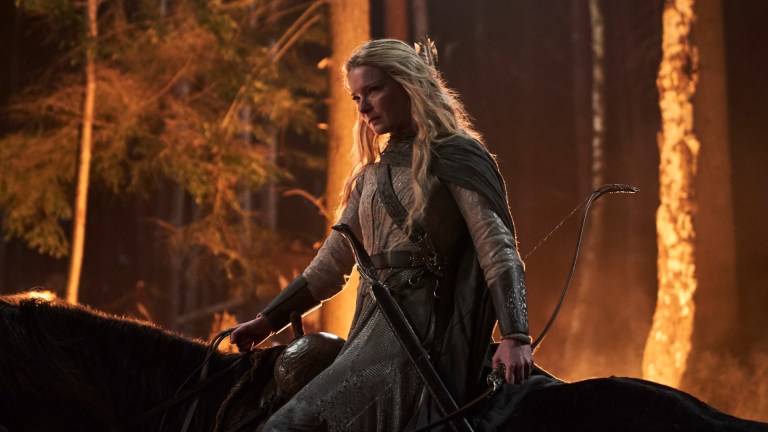 Morfydd Clark as Galadriel rides horseback as a forest burns in the background in Prime Video's The Rings of Power